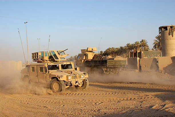 Army car going to its base on a dirty road View of Armored HMMWV in Iraq.  military land vehicle stock pictures, royalty-free photos & images
