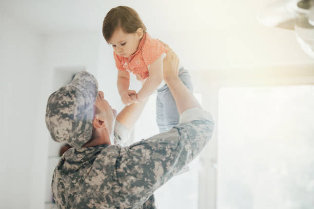 Army Dad Reunites With His Little Girl  veterans returning home stock pictures, royalty-free photos & images