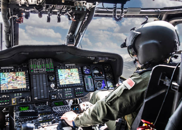 Army Helicopter Pilot riding helicopter Army Helicopter Pilot riding helicopter cockpit stock pictures, royalty-free photos & images