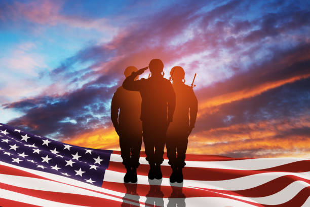 USA army soldiers saluting with nation flag. Greeting card for Veterans Day, Memorial Day, Independence Day. stock photo