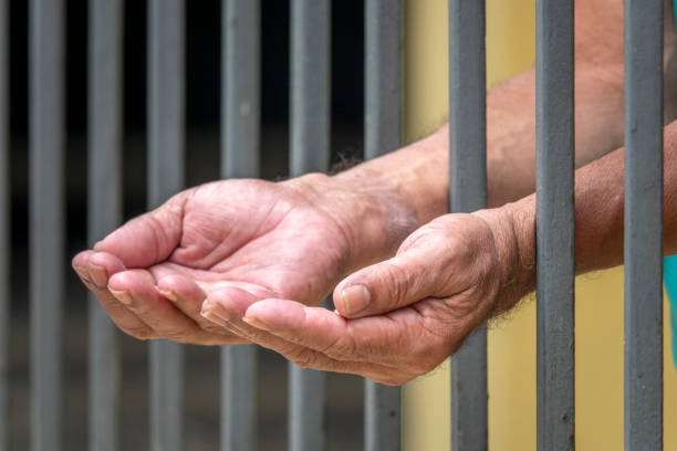 Arrested man makes order with his hands stock photo