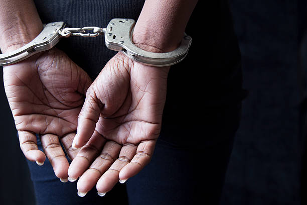 Arrested Black woman in handcuffs restraining stock pictures, royalty-free photos & images