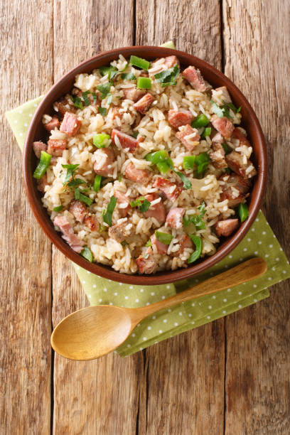 Arroz Carreteiro Brazilian Wagoners Rice with meat and vegetables close up in the bowl. Vertical top view stock photo