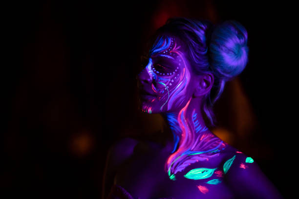 Art Avant-Garde Night portrait of a beautiful girl with fluorescent body paint. paint neon color neon light ultraviolet light stock pictures, royalty-free photos & images