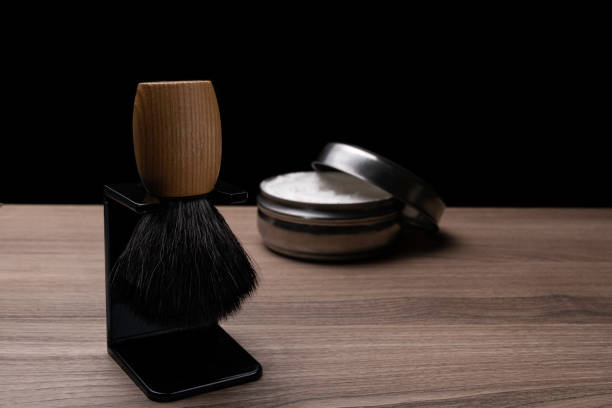 Artisan set with shaving brush and cream on wood background. stock photo