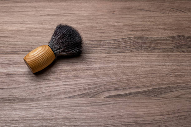 Artisan shaving brush on wood background. stock photo