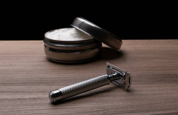 Artisan shaving cream and security razor on wooden background stock photo