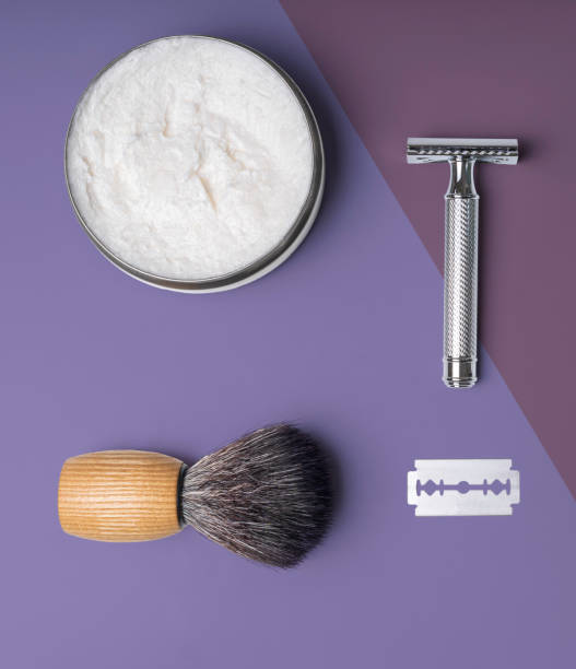 Artisan shaving set with cream, security razor, razor blade shaving brush and bowl on colorful background. stock photo