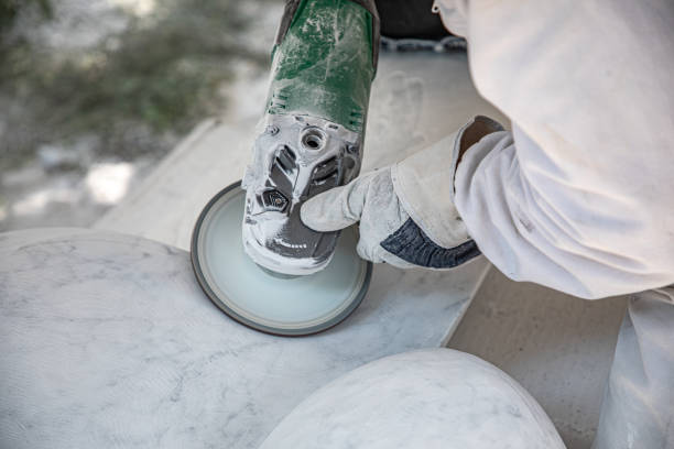 artist who works marble with circular saw stock photo