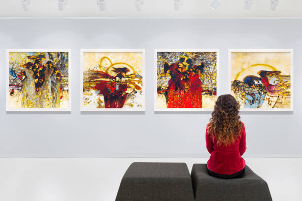 Artist's collection at showroom In a art gallery young woman visits an art exhibition and watches artist's collection. art museum stock pictures, royalty-free photos & images