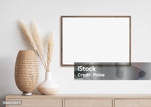 istock Artwork mock-up in interior design. Blank white picture frame on a white wall 1350431073