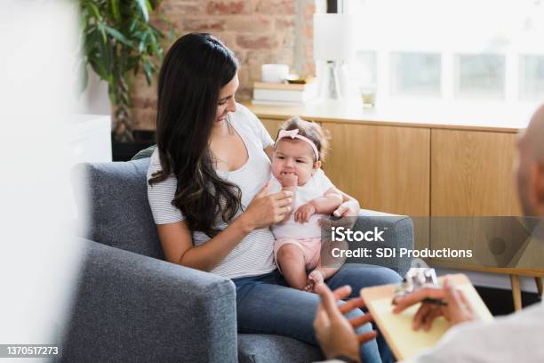 As therapist talks, mom looks at baby daughter