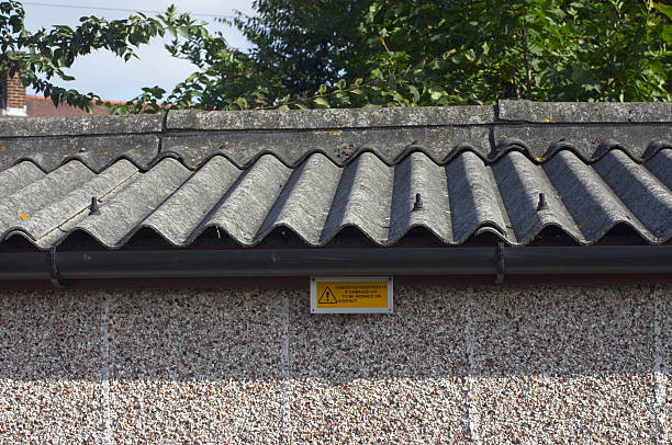 Asbestos roof and warning sign stock photo