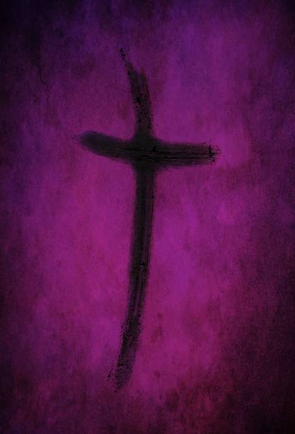 Ash cross drawn with finger on purple lenten backdrop Ash cross made from burned palm crosses isolated on purple and black speckled background. Ash Wednesday, repentance and hope in Christ concept. lent stock pictures, royalty-free photos & images