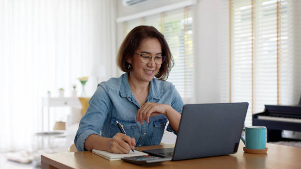 Asia adult happy people or sme owner latin lady sit consult talk in online seminar reskill upskill job discuss class for worker on desk table work at home in remote teach advice by digital training. stock photo