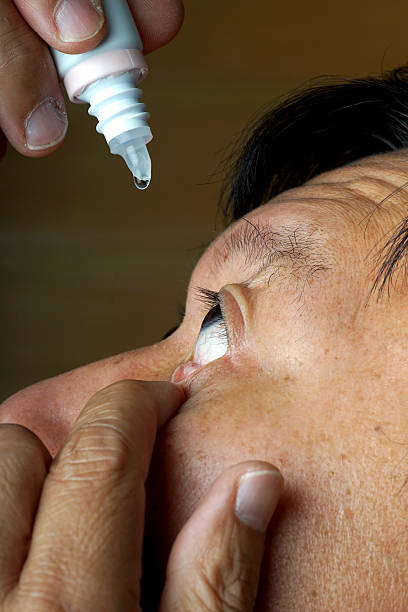 asia man use medicine eyedropper stock photo