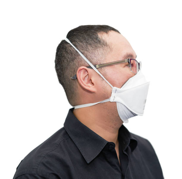 asia man wear n95 protection corona virus mask isolated on whtie in pandemic covid 19 wear glasses side view stock photo