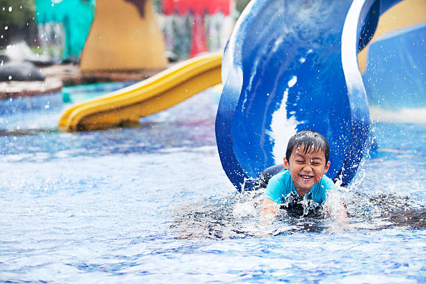 Asian boy having fun at swimming pool stock photo