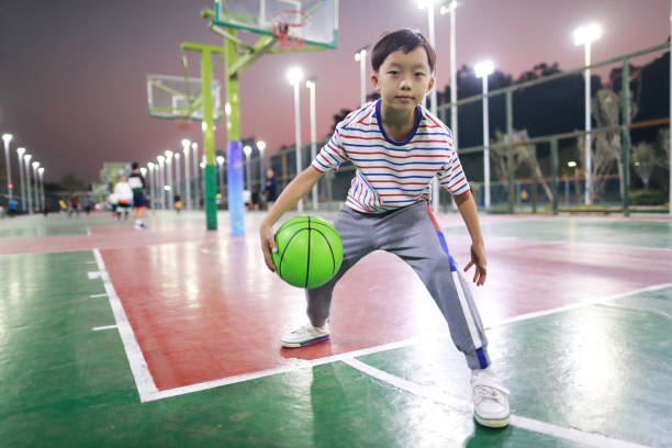 Asian boy playing basketball stock photo