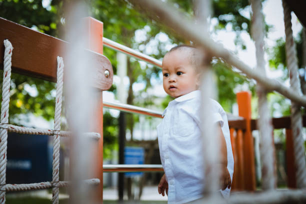 Asian boy playing in the playground stock photo