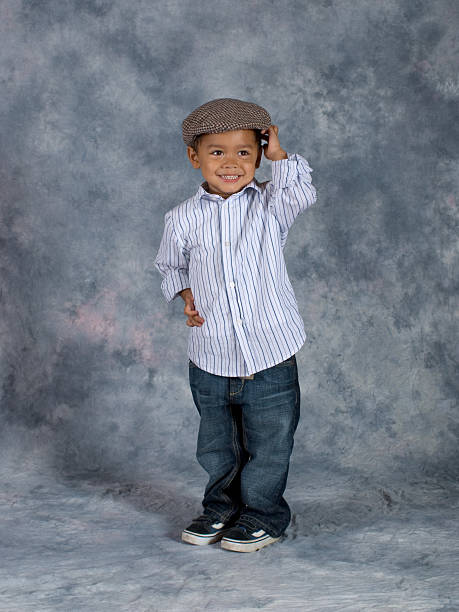 Asian Boy Standing School Pose Hands on Hat stock photo
