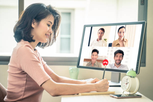 Asian business woman talking to colleague team about plan in video conference. Group of multiethnic business people using computer for online meeting in video call conference. Smart working from home. Asian business woman talking to colleague team about plan in video conference. Group of multiethnic business people using computer for online meeting in video call conference. Smart working from home. online meeting asian stock pictures, royalty-free photos & images