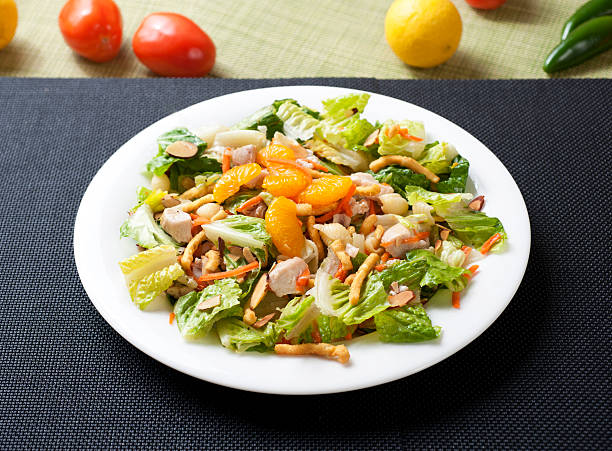 Asian Chicken Salad Asian Style Chicken & Romaine Salad with Tangerine & Wonton Strips chicken salad stock pictures, royalty-free photos & images