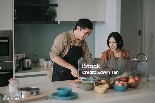 istock asian chinese couple preparing ingredients cooking meals for family at kitchen counter 1297134165