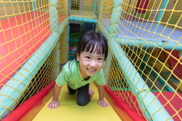 Asian Chinese little girl playing slide stock photo