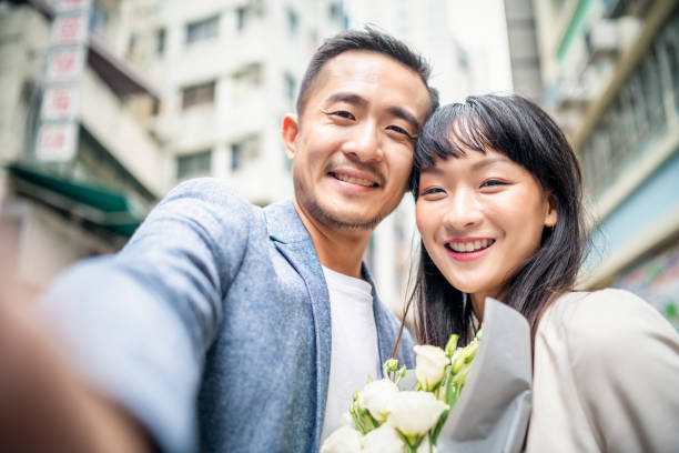 Asian couple taking a selfie stock photo