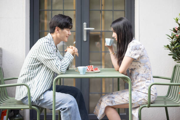 Asian couples dating in outdoor cafes stock photo