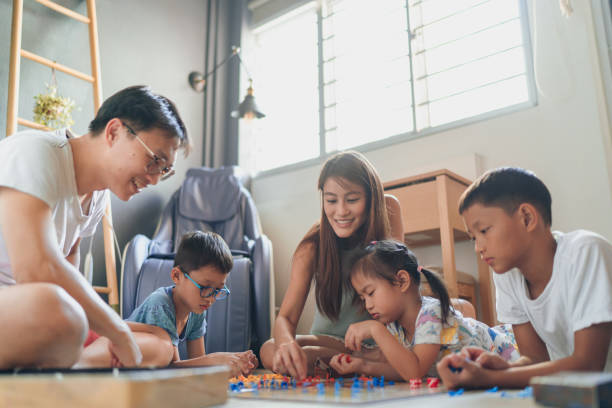 Asian family bonding together at home during the weekend stock photo