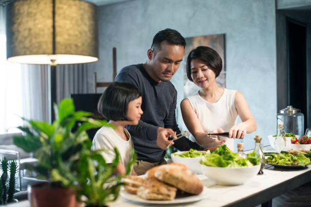 Asian family cooking at home. stock photo