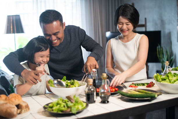 Asian family cooking at home. stock photo
