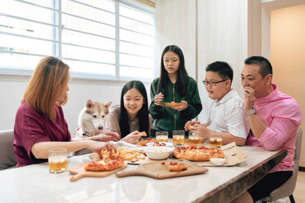 Asian family having a meal together stock photo