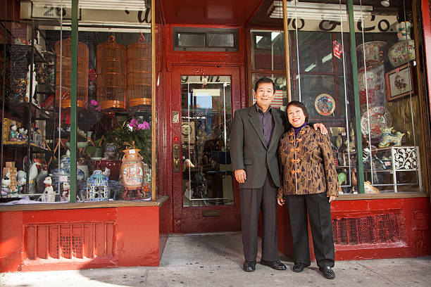 Asian family in front of store Asian family in front of store chinatown stock pictures, royalty-free photos & images