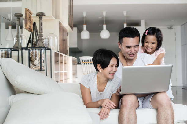 Asian family looking at the computer together. stock photo