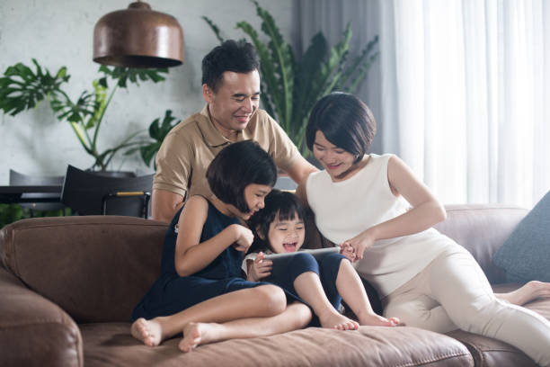 Asian family spending time together at home. stock photo