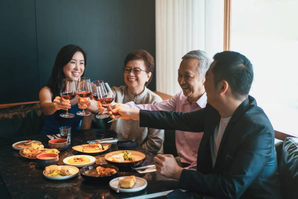 Asian family toasting for a joyous occasion stock photo