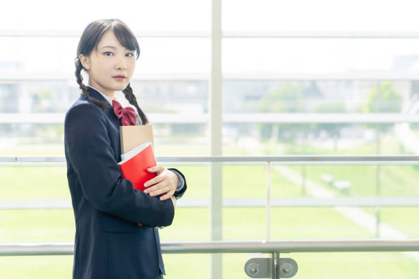 Asian female high school student in school building. Asian female high school student in school building. chinese girl hairstyle stock pictures, royalty-free photos & images