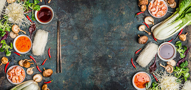 Asian food background with various of cooking ingredients Asian food background with various of cooking ingredients on rustic background , top view , banner.  Asian food concept: Chinese or Thai cuisine. asian food stock pictures, royalty-free photos & images