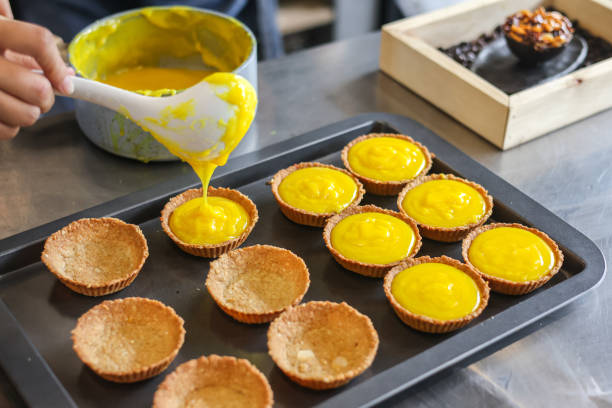 Asian girl cooking egg tart bakery . Houseworking food lifstyle and family concept. stock photo
