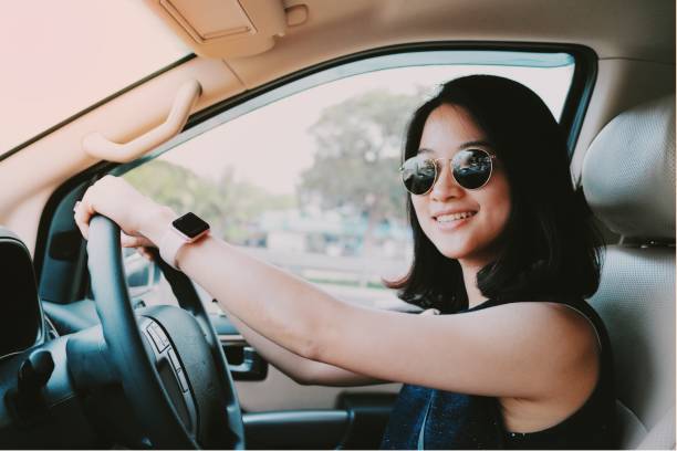 Asian girl driving a car stock photo