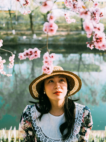 Asian Girl Enjoying Cherry Blossoms in Spring