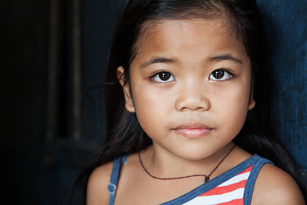 Asian girl portrait Asian child portrait - young girl from the Philippines against wall - natural light philippine girl stock pictures, royalty-free photos & images
