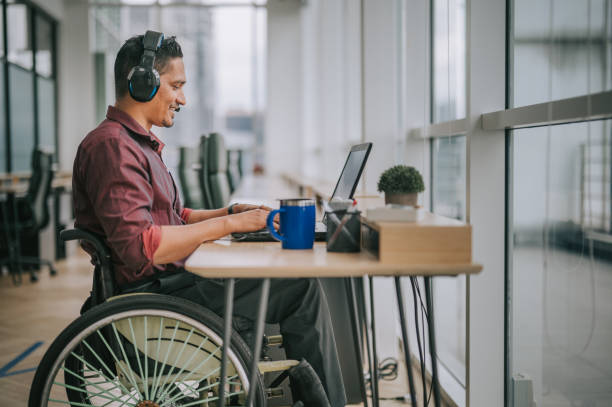 asian indian male white collar worker with disability on wheelchair talking to the camera video calling video conference with his business partners asian indian male white collar worker with disability on wheelchair talking to the camera video calling video conference with his business partners distance learning stock pictures, royalty-free photos & images