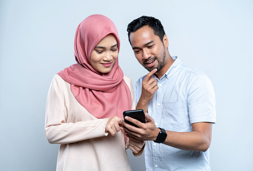 Asian Malay Couple Doing Online Shopping On Mobile Phone Asian Malay Couple Doing Online Shopping On Mobile Phone