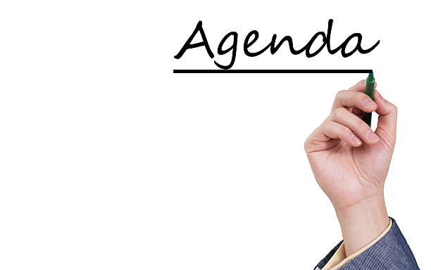 asian male hand writing agenda on white board - agenda stockfoto's en -beelden