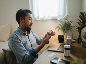istock Asian man a video telemedicine call with a doctor. 1311961863
