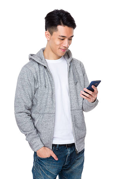 Asian man holding a smartphone stock photo